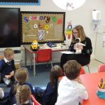 Sian reading her story to Reception class