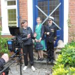 Claudia Gray directs a scene with Commander & Mrs Lowe Connor Crowley on camera